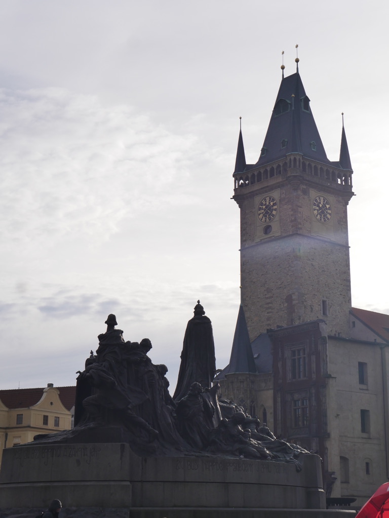 Jan Hus memorial and the Old Town Hall tower in Prague photographed by Oskar Olszewski