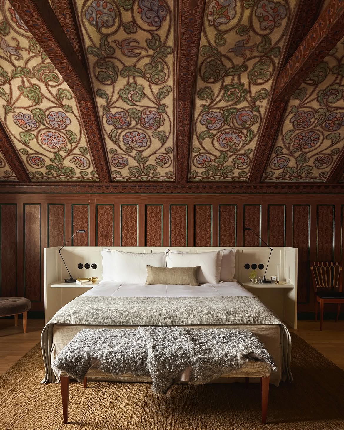 Attic suite with a hand-painted vaulted ceiling and warm wood panelling