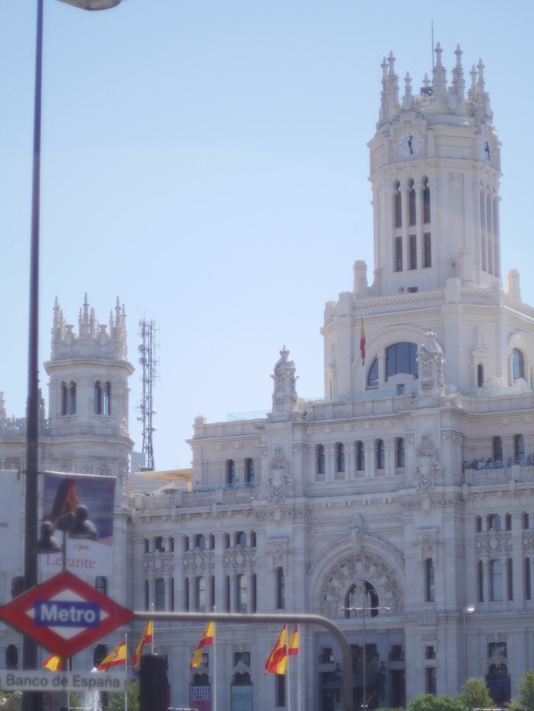 Palacio de Cibeles in Madrid behind a Metro sign photographed by Oskar Olszewski