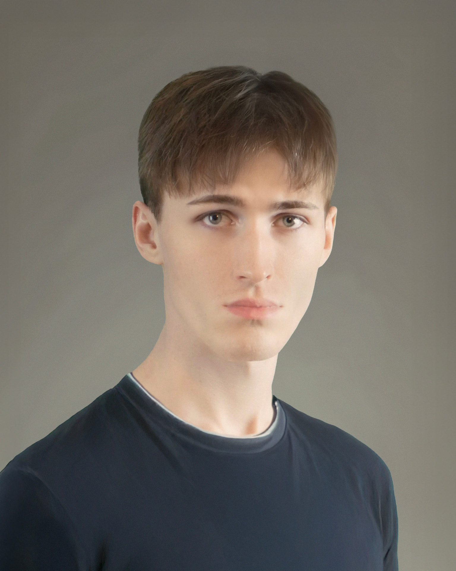 Portrait of Oskar Olszewski in a dark t-shirt against a neutral grey background